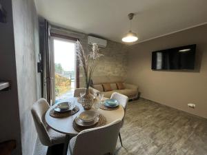 a dining room with a table and chairs and a couch at Casa del Duca Portoferraio in Portoferraio