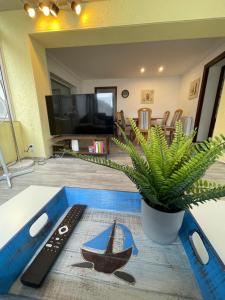 a living room with a table with a boat on it at FeWo Renken in Trassenheide