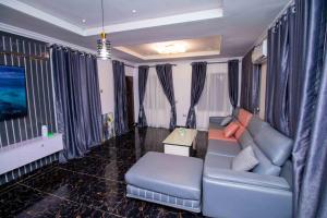 a living room with a couch and a table at Living Space Apartment in Ibadan