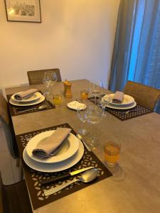 a table with plates and wine glasses on it at Les Chicoufs in Saujon +11 photos