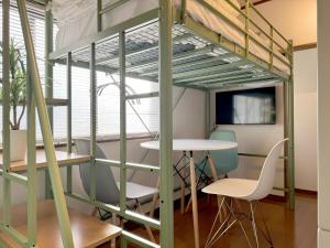 a room with a loft bed and a table and chairs at JindaijiStudio SAZU222 in Chofu