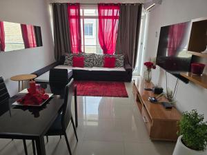 a living room with a couch and a table at My Flat 2 in Praia