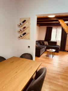 a living room with a wooden table and a couch at Planinski šapat in Blidinje +15 photos