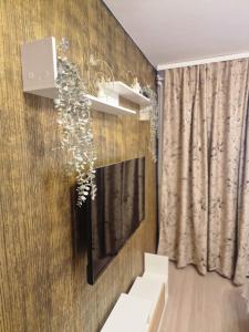 a living room with a television and a curtain at Studio Maria in Bucharest