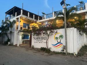 a building with a sign for a hotel at Hotel Palmera Beach in Cartagena de Indias