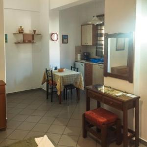 a kitchen with a table and a table and chairs at Kampos Bliss Studios in Votsalákia