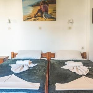 a bedroom with two beds with towels on them at Kampos Bliss Studios in Votsalákia