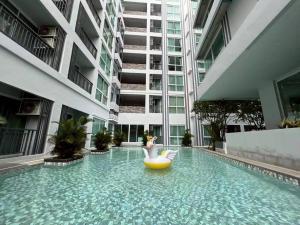 a swimming pool in the middle of a building at Condo D-Eco Wellness Center A8721 in North Pattaya
