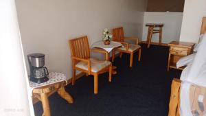 a room with chairs and a table with a coffee maker at Hotel White Sandcastle Mara in Sekenani
