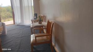 a room with chairs and a table and a window at Hotel White Sandcastle Mara in Sekenani