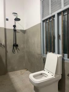 a bathroom with a toilet with a camera on the wall at Far view villa in Galle +10 photos