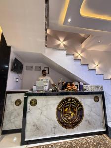 a man is standing behind a counter in a restaurant at Hotel JP palace in Orchha