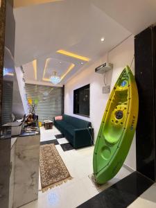 a living room with a green kayak on the wall at Hotel JP palace in Orchha