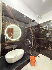 a bathroom with a sink and a mirror at Hotel JP palace in Orchha