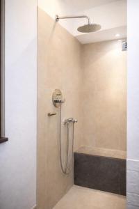 a bathroom with a shower with a glass door at Spinuzza Boutique Guesthouse Cefalù, Sicily in Cefalù +16 photos