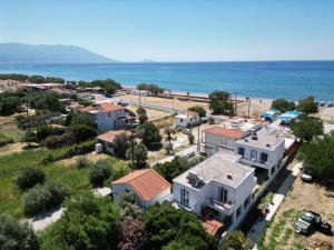 an aerial view of a small town next to the ocean at Kampos Bliss Studios in Votsalákia +12 photos