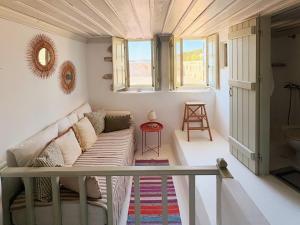 a living room with a couch and a table at Agnanti Beach House in Patmos
