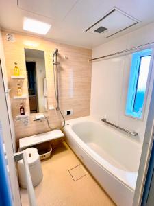 a bathroom with a white tub and a sink at Ueno 10minutes, Tokyo University 10minutes, three BR, three toilets, Max 10 people Free parking in Tokyo +85 photos