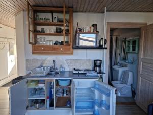 a small kitchen with a sink and a toilet at Lillebo fred og ro in Græsted +9 photos