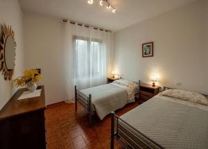 a hotel room with two beds and a window at Il loggiato del chianti in Cavriglia +31 photos