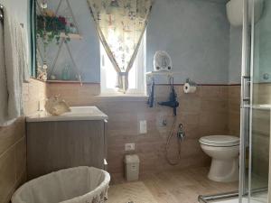 a bathroom with a toilet and a sink at La Terrazza Solarium, in pieno centro 60m dalla stazione ferroviaria 700m dal mare in Santa Flavia +37 photos