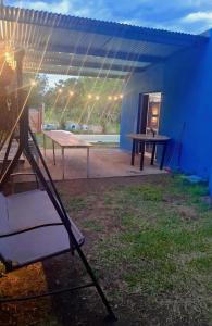 a patio with a ping pong table and a blue house at Cande in Parana