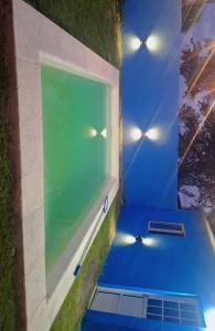 a room with a window and a blue floor at Cande in Parana