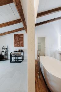 a large white bath tub in a room with a table at Palazzo Mimì in Bitritto +126 photos