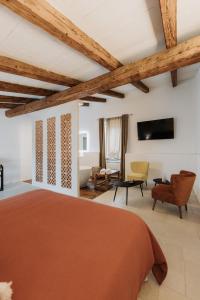 a bedroom with a large bed and a living room at Palazzo Mimì in Bitritto