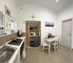 a kitchen with a sink and a stove at Civico77AirPort in Naples
