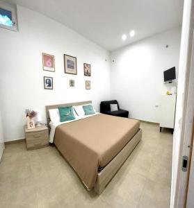 a bedroom with a bed and a chair in it at Civico77AirPort in Naples