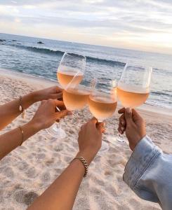 a group of people holding up wine glasses on the beach at departamento Vacacional, frente al mar in Playas