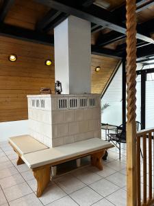 a bench sitting on a porch with a fireplace at Haus Anna in Oberdachstetten