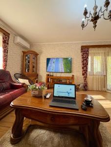 a laptop computer sitting on a wooden table in a living room at Villa Piste - Skadar Lake in Virpazar