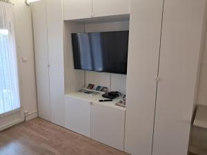 a living room with a flat screen tv on a wall at Studio BERNARD in Saint-Cyr-sur-Mer