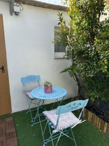 a table and two chairs and a table with a plant at Buganvilla in Tarifa