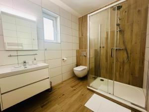 a bathroom with a shower and a sink and a toilet at Apartmány Stagnum Liptovský Ján in Liptovský Ján +12 photos