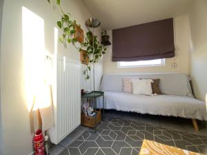 a small bedroom with a bed and a window at Top Floor Apt with Balcony - Acropolis View & Sunset - Koukaki in Athens
