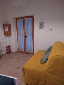 a bedroom with a bed and a glass door at Casa nonna Gina in Genoa