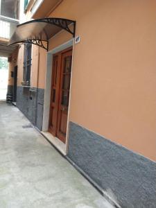 an entrance to a building with a wooden door at Casa nonna Gina in Genoa
