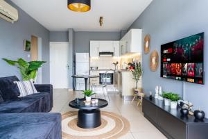 a living room with a couch and a table at 1BR Apt. next to Coralli Beach Protaras in Paralimni +8 photos