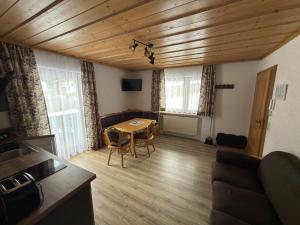 a living room with a table and a couch at Haus Monica in Bodenmais