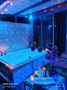 a jacuzzi tub in a room with blue lights at Finca San Miguel Filandia in Filandia