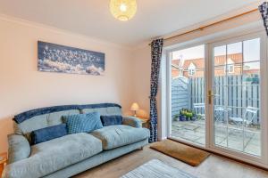 a living room with a couch and a sliding glass door at 2 Bed in Snettisham oc-d31668 in Snettisham