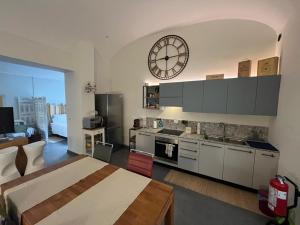 a large kitchen with a large clock on the wall at Il TRE del TRENTA in Turin