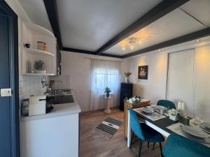 a kitchen and dining room with a table and chairs at Stephan house in Tremblay-En-France