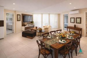 a living room with a table and chairs and a couch at Palm Beach 206 BL 4 by Holiday Stays in Aquiraz
