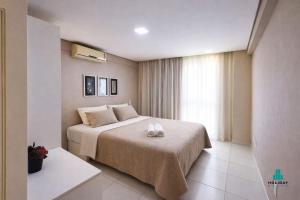 a bedroom with a bed with two towels on it at Palm Beach 206 BL 4 by Holiday Stays in Aquiraz +11 photos