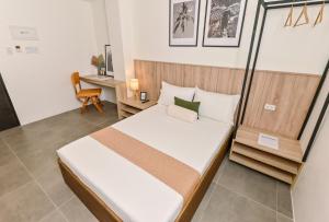 a small bedroom with a bed and a desk at Casa Charlie Hotel in Manila +51 photos