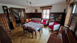 a living room with a table and chairs at Gîte Eugénie in Aspach-le-Bas +9 photos